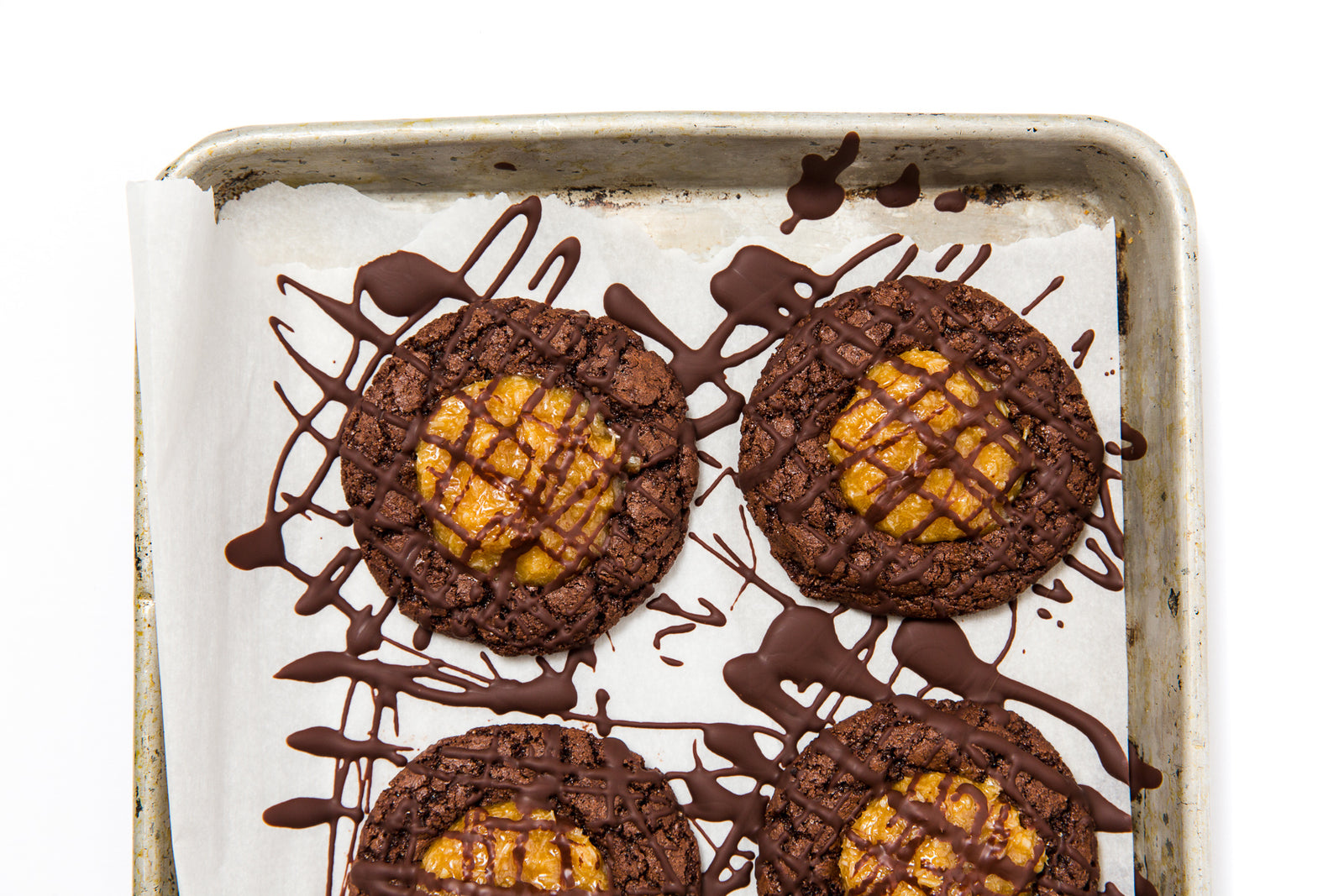 Image of top of four Miss Jones Baking Co Coconut Caramel Brownie Cookies on baking sheet