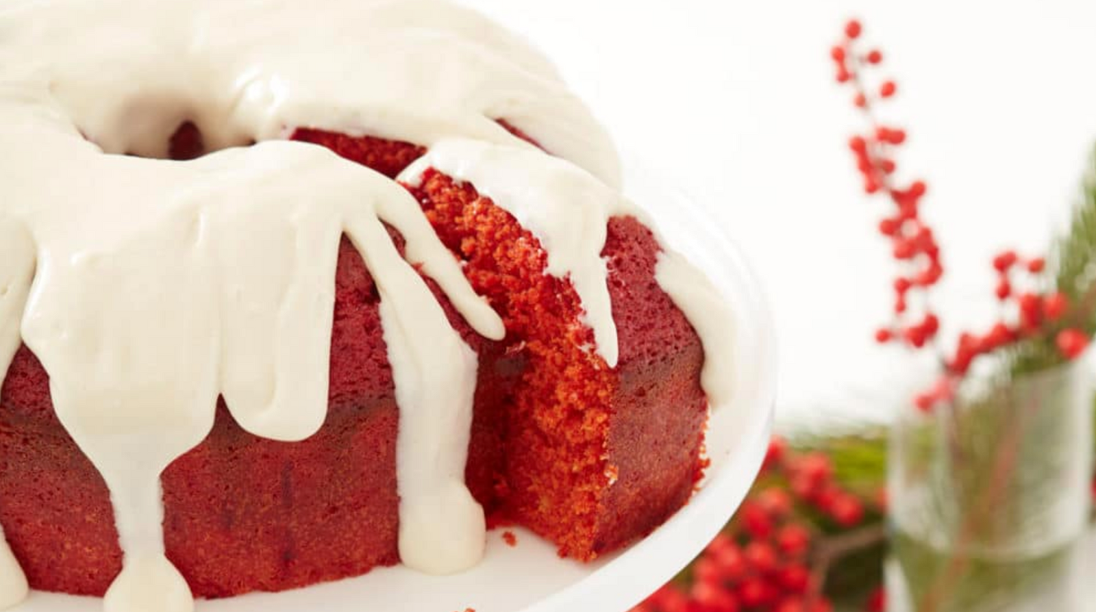 Image of Miss Jones Baking Co's Red Velvet Bundt Cake and Cream Cheese Glaze with a slice being cut