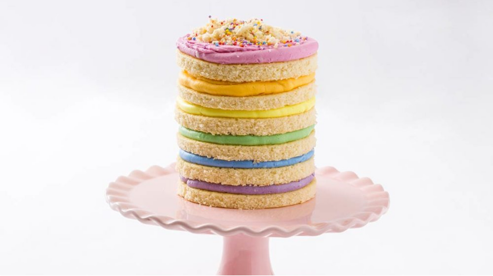 Image of Miss Jones Baking Co Somewhere Over the Rainbow Layer Cake, a birthday cake of a Naturally Dyed Rainbow Frosted Layer Cake