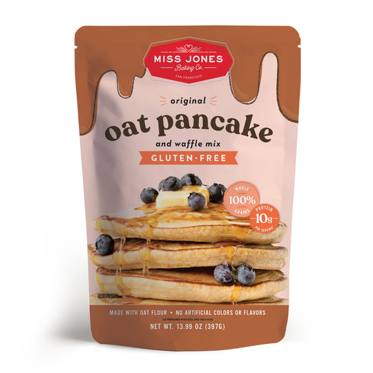 Packaging of Miss Jones Gluten-Free Original Oat Pancake and Waffle Mix with an image of pancakes with blueberries on top.